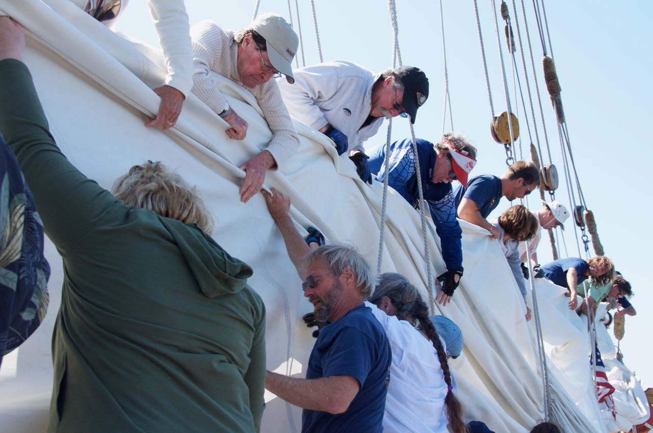 volunteer crew working the sails on the Schooner Zodiac